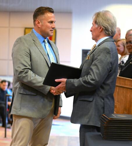 A BLET graduate shakes hands with Dr. Sorrells before receiving his certificate.