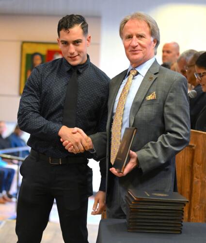 A BLET graduate shakes hands with Dr. Sorrells before receiving his certificate.
