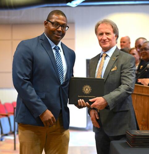 A BLET graduate poses with Dr. Sorrells after receiving his certificate.
