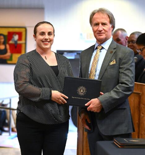 A BLET graduate poses with Dr. Sorrells after receiving her certificate.
