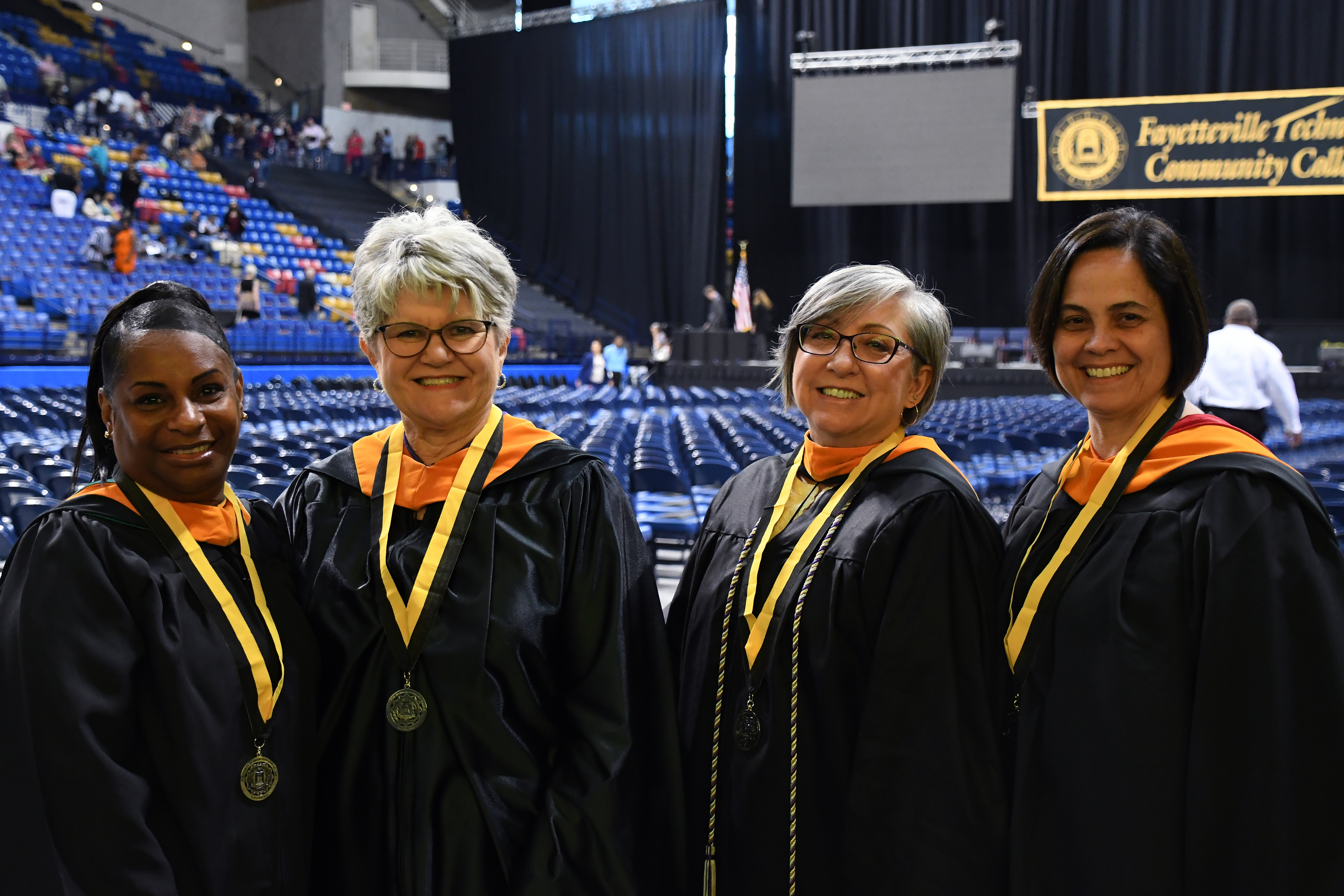 Four faculty members pose for a photo.