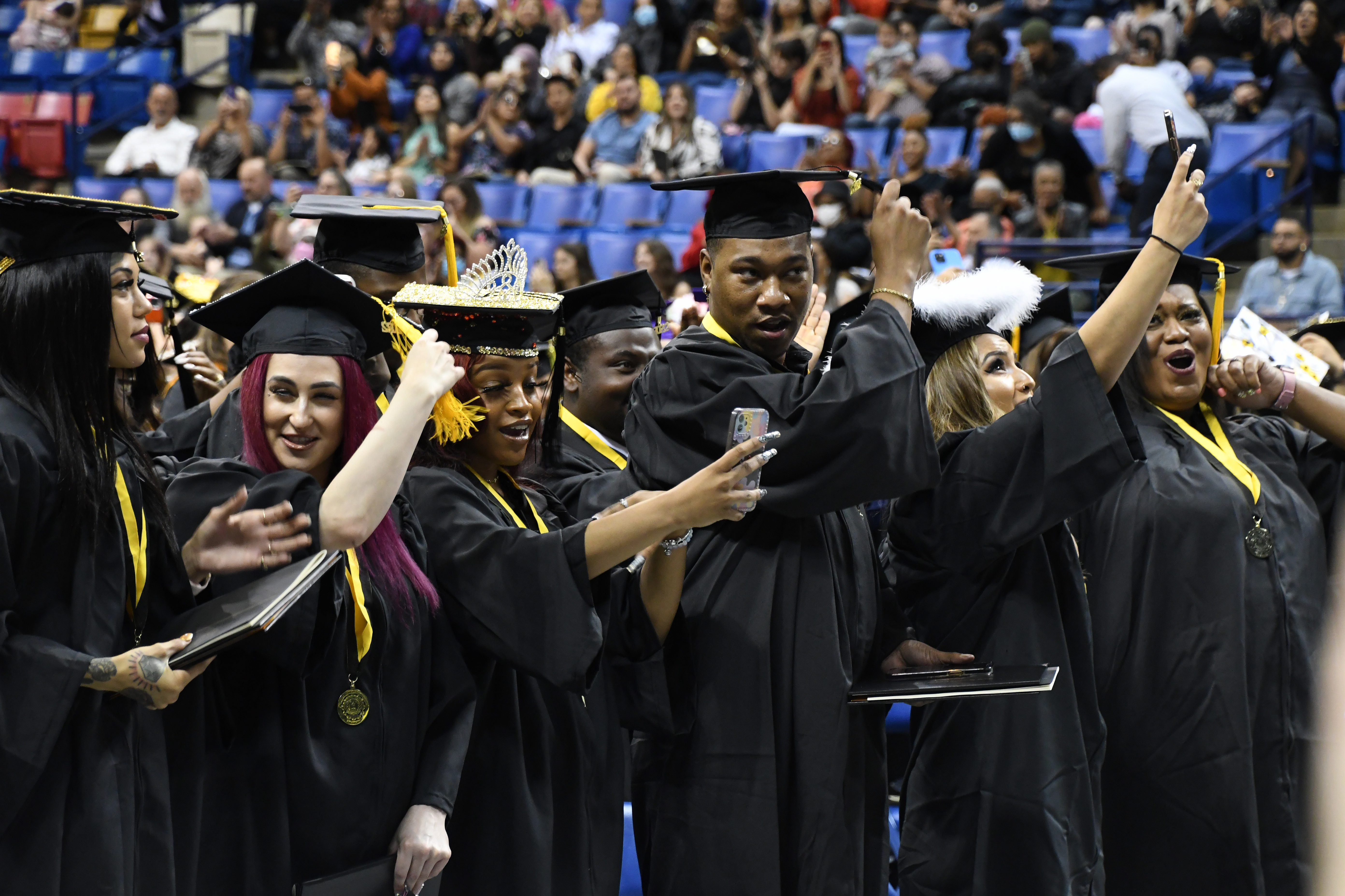 A row of graduates turn their tassels to the left.