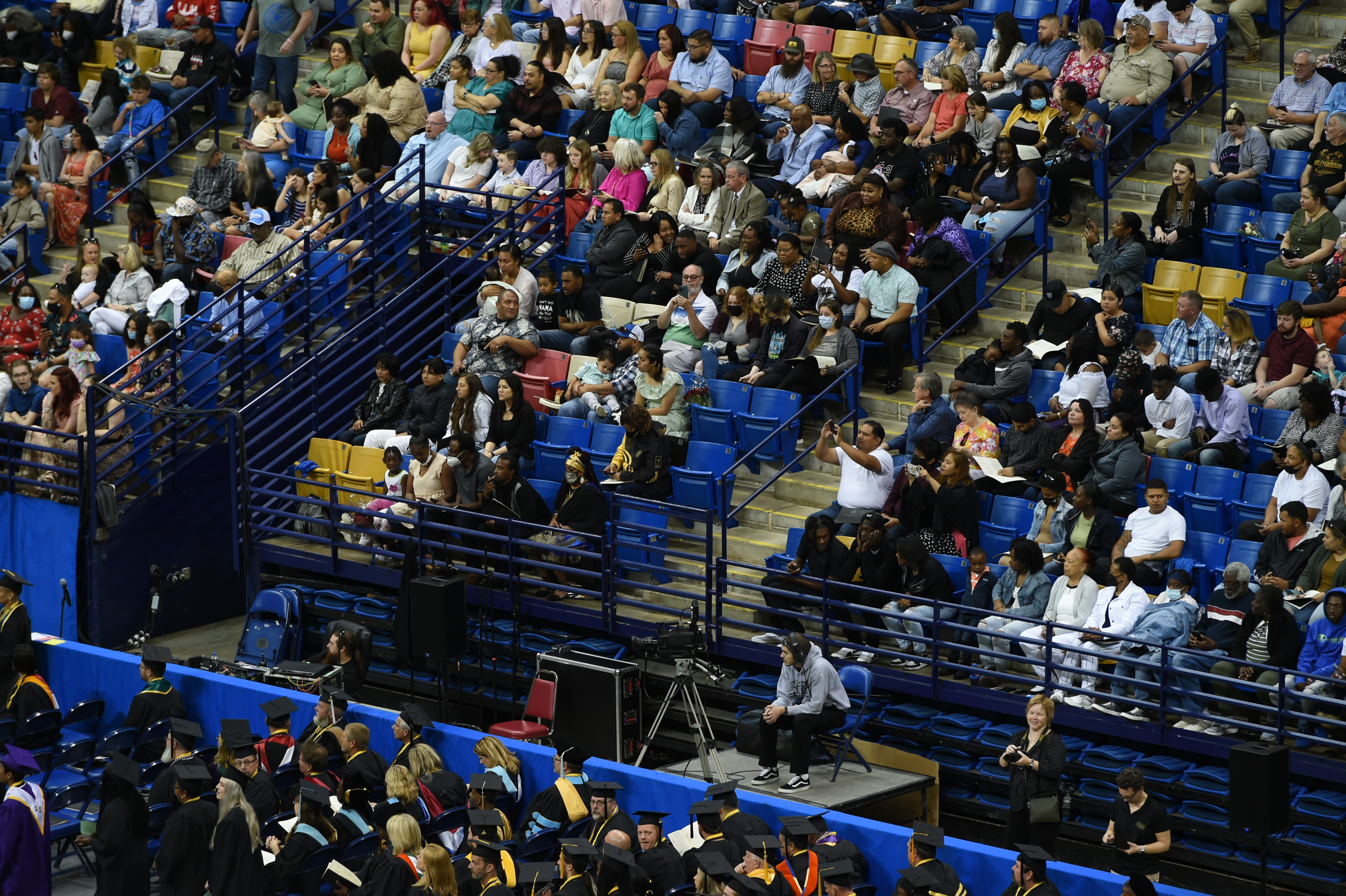 A wide photo of the crowd in the stands at graduation.