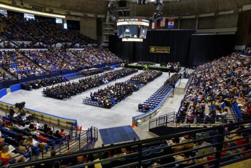 A wide photo shows the entire floor, stage and parts of the audience for the 10 a.m. ceremony in the Crown.