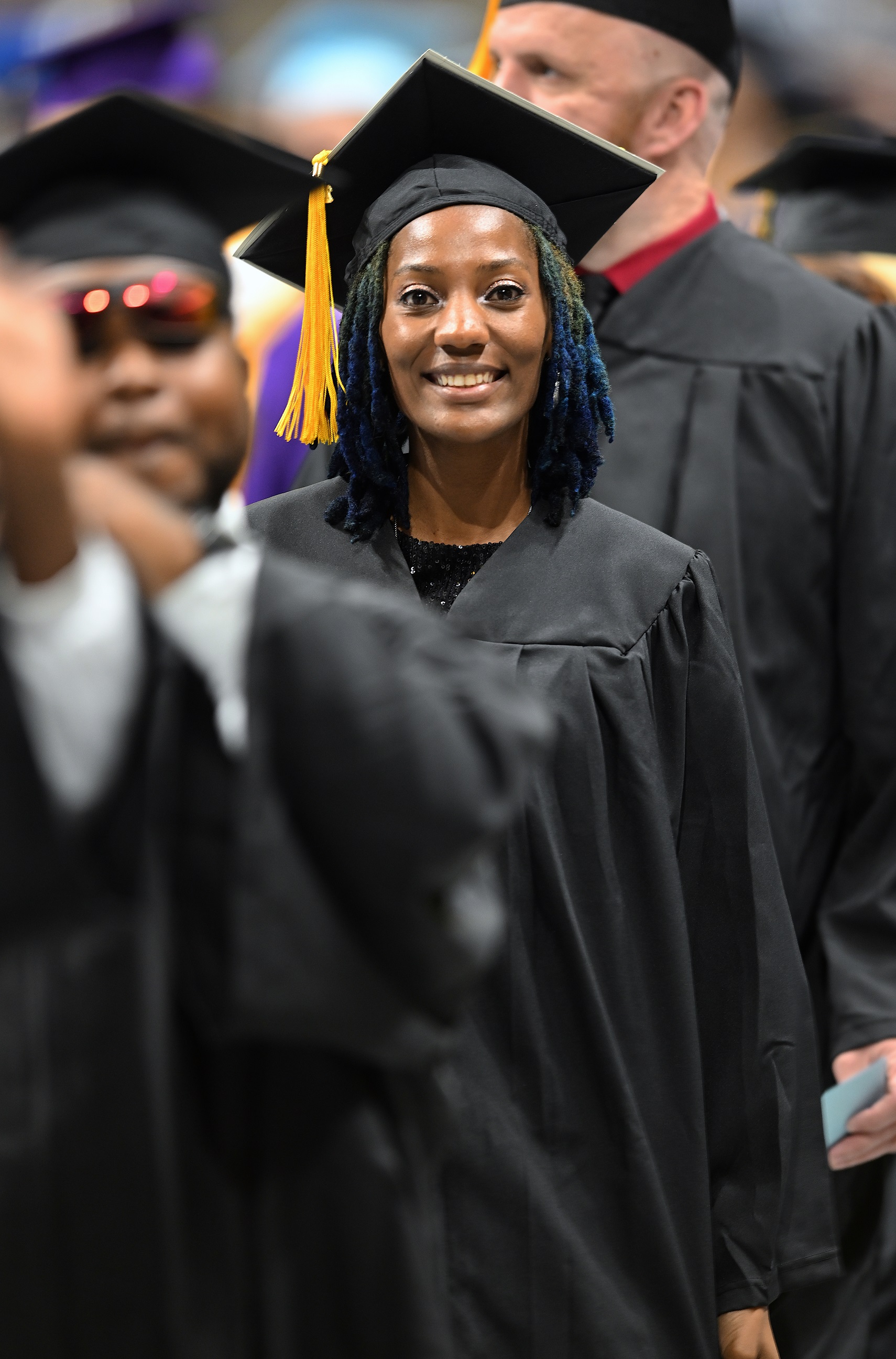 A graduate smiles as she enters the Crown floor.