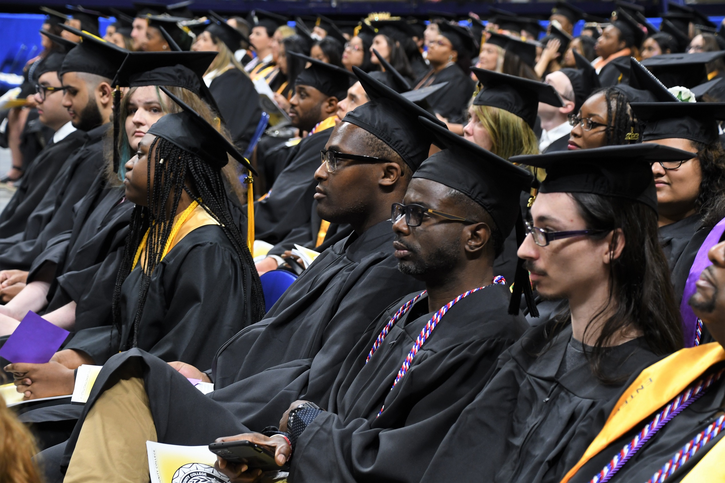 Graduates sit in rows during the Commencement ceremony.