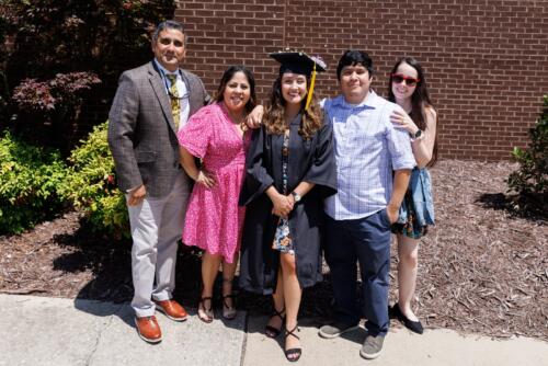 A graduate poses with her loved ones outside of the Crown.