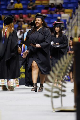 A graduate walks across the stage.