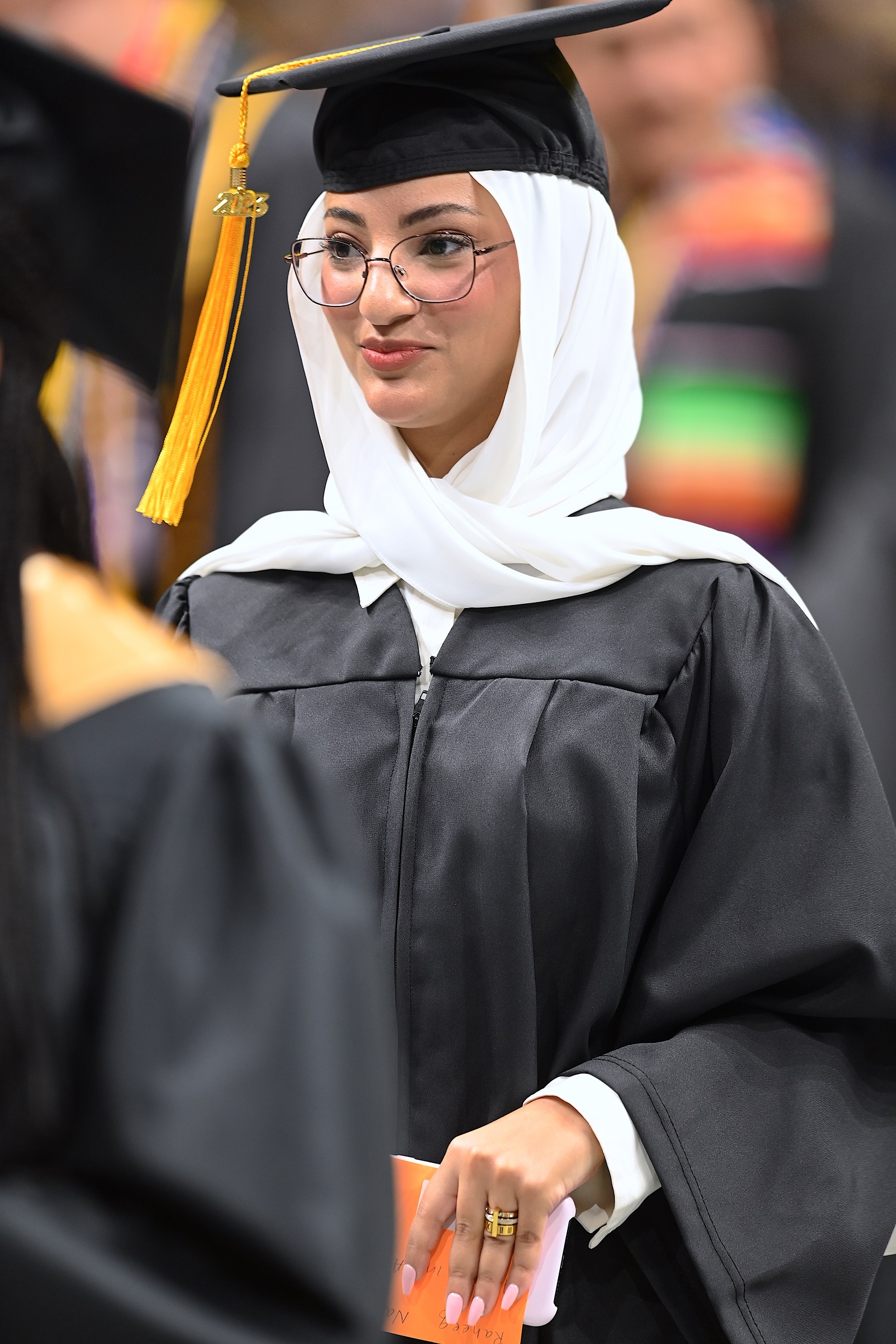 A close-up of a graduate walking into the Crown.