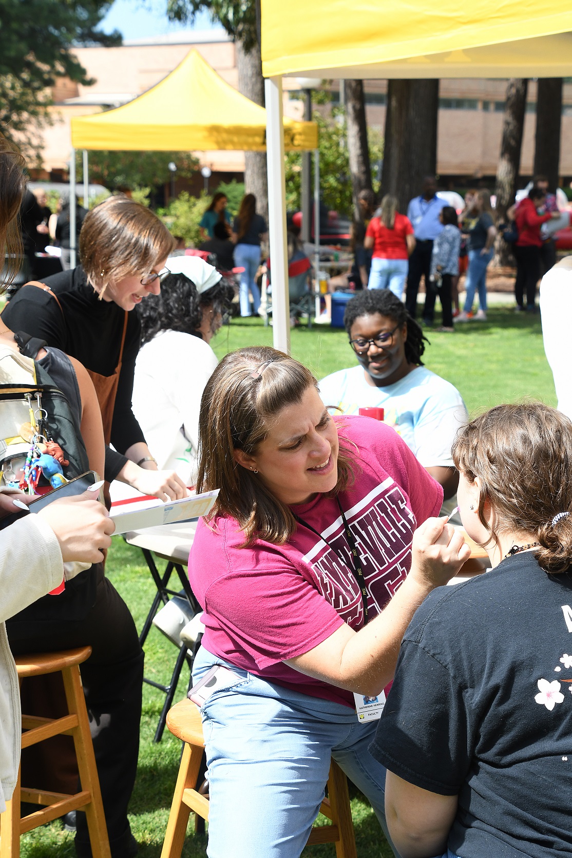 A student gets her face painted.