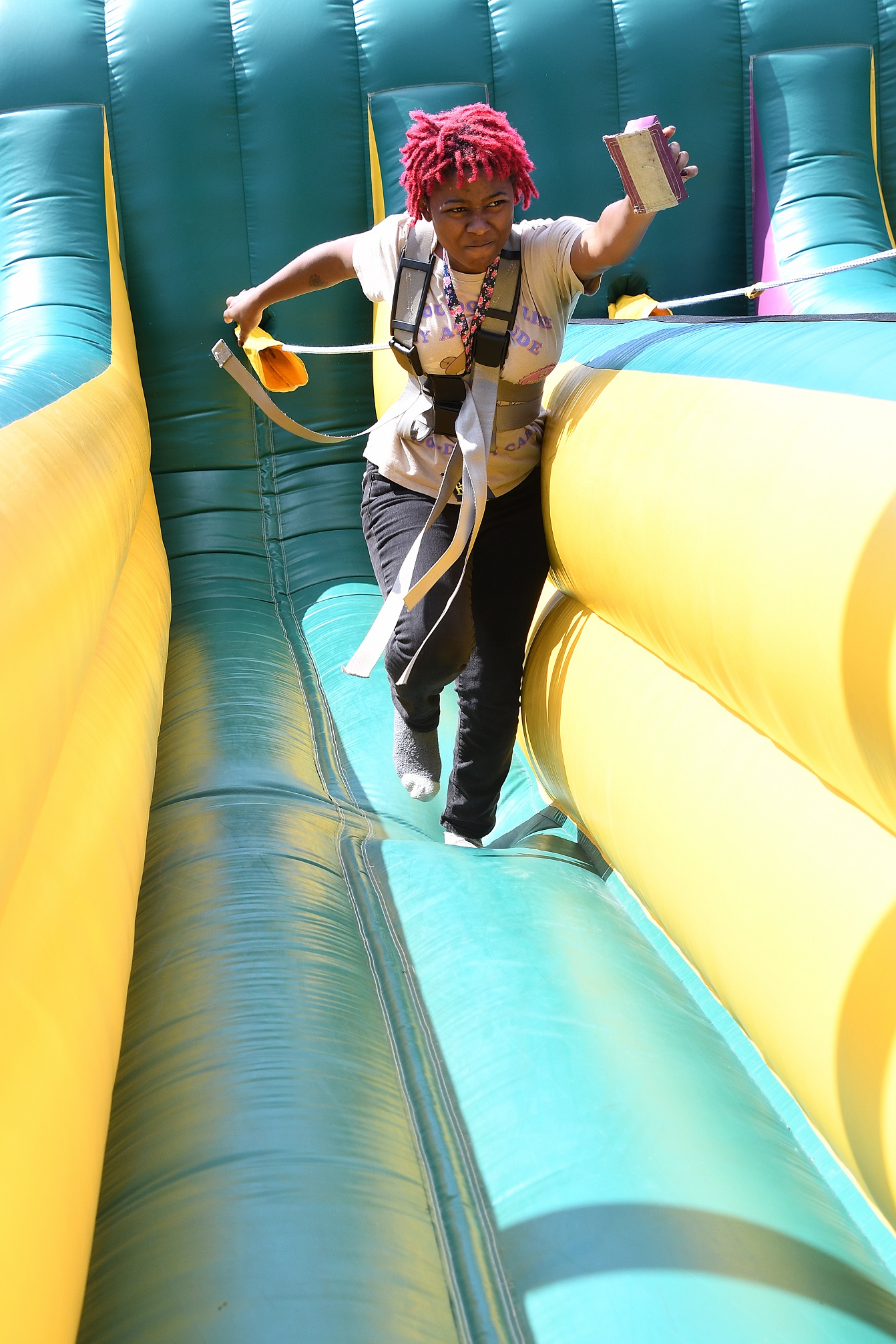 A student runs on an inflatable obstacle.