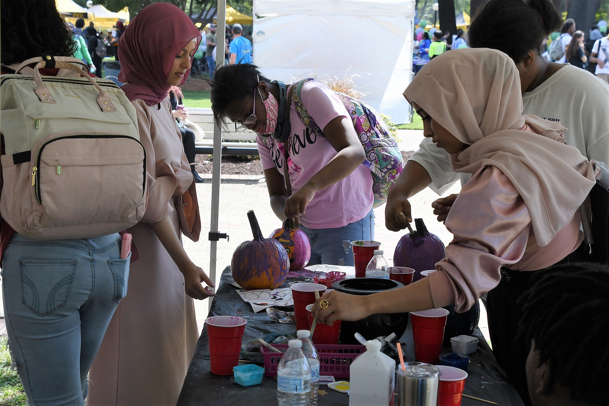 Students paint pumpkins.