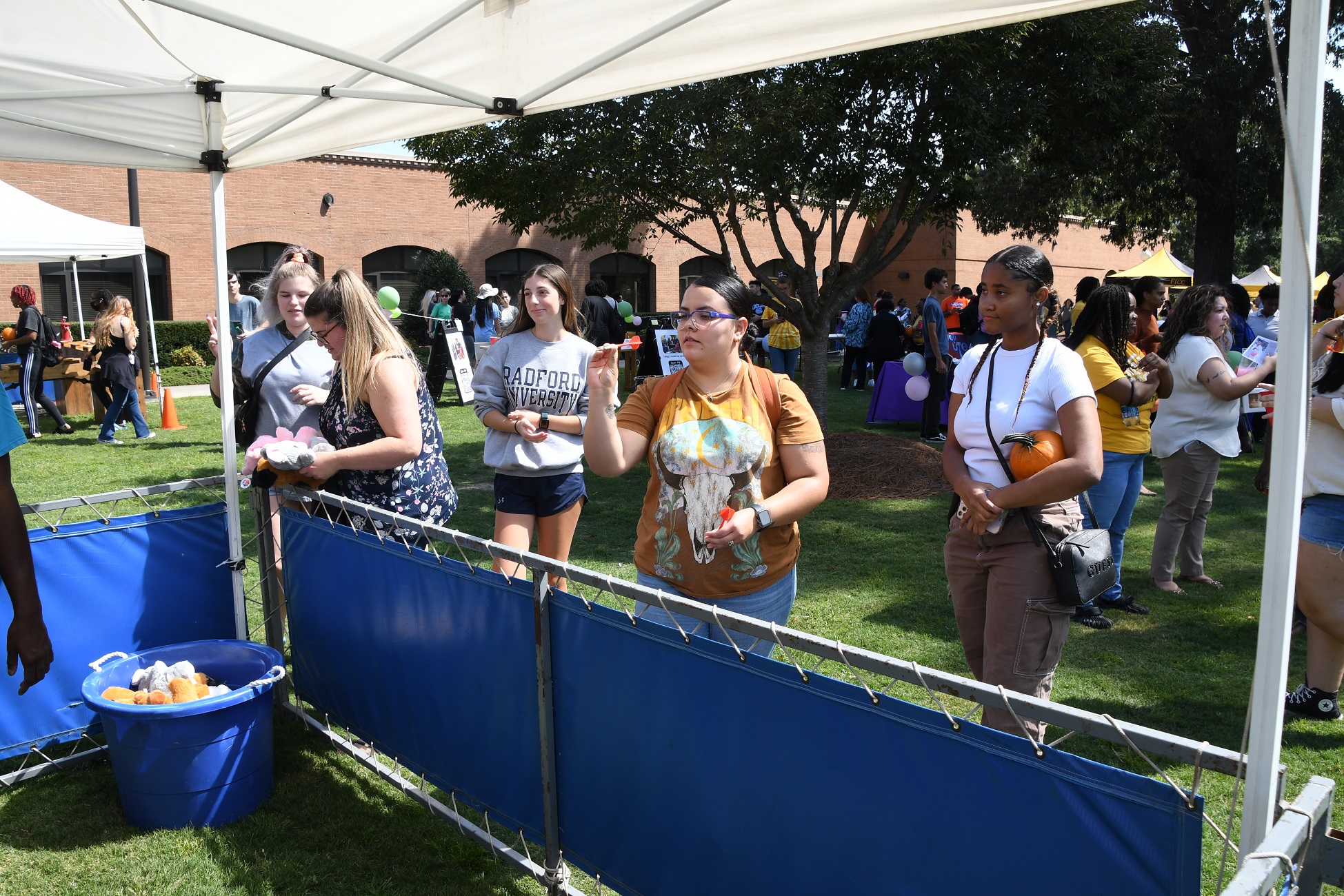 A student prepares to throw a dart.