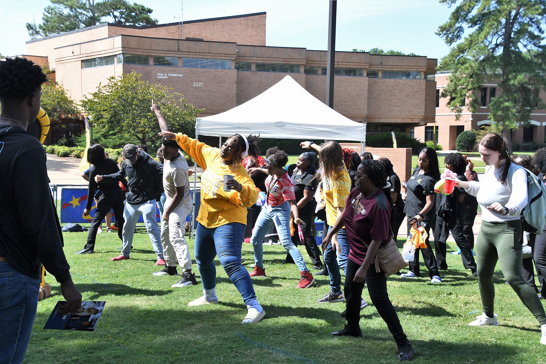 Rows of students dance on the Tony Rand Lawn.