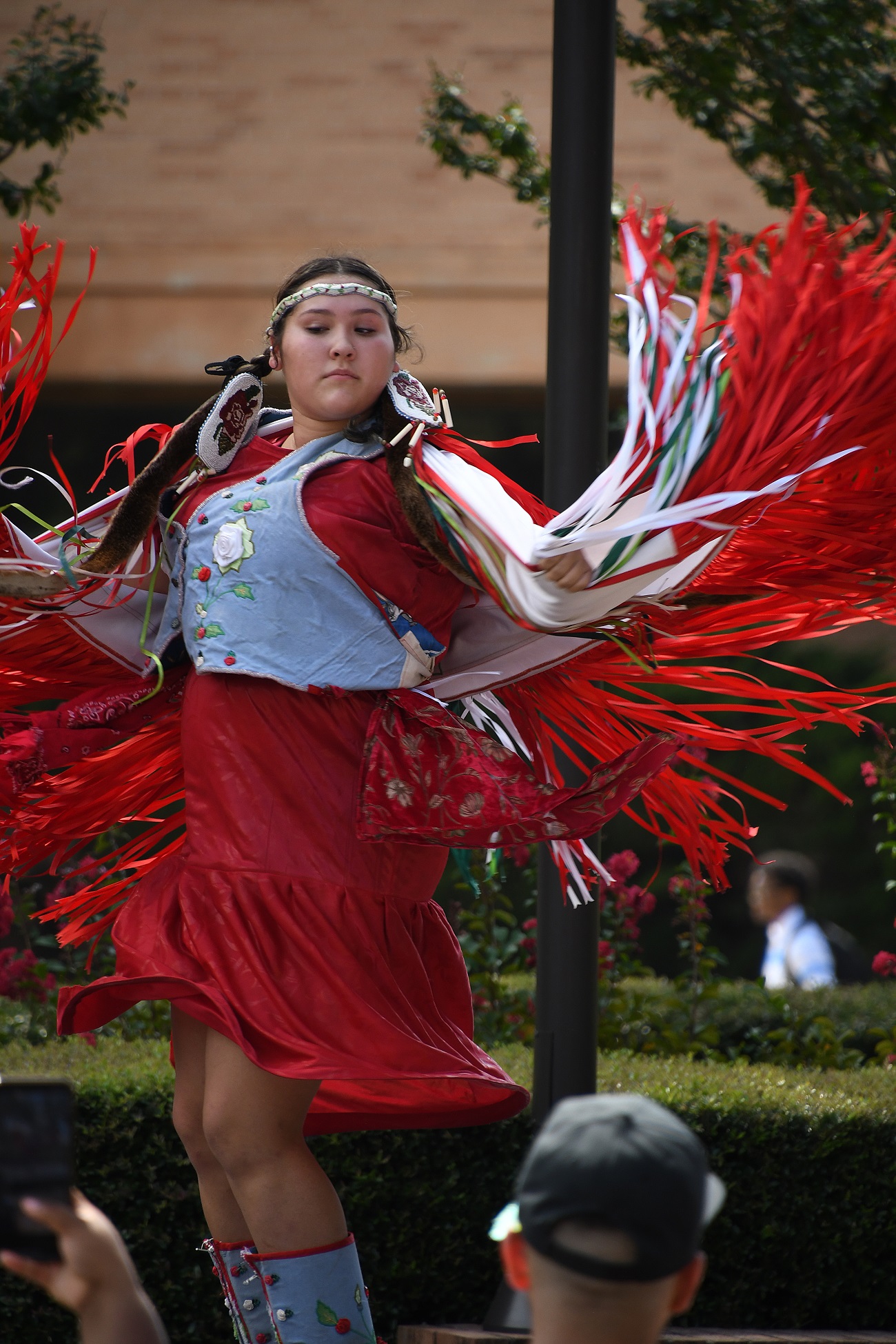 A Native American dancer performs on stage.