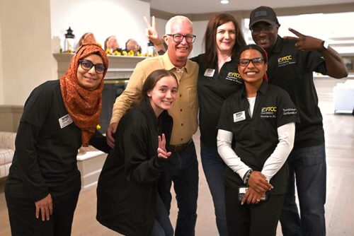 Group Photo Inside Blue Grass Building