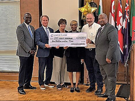 County Commissioners Charles Evans, Toni Stewart, Jimmy Keefe and Glenn Adams as well as FTCC vice president Mark Sorrells and county manager Amy Cannon pose with a large check.