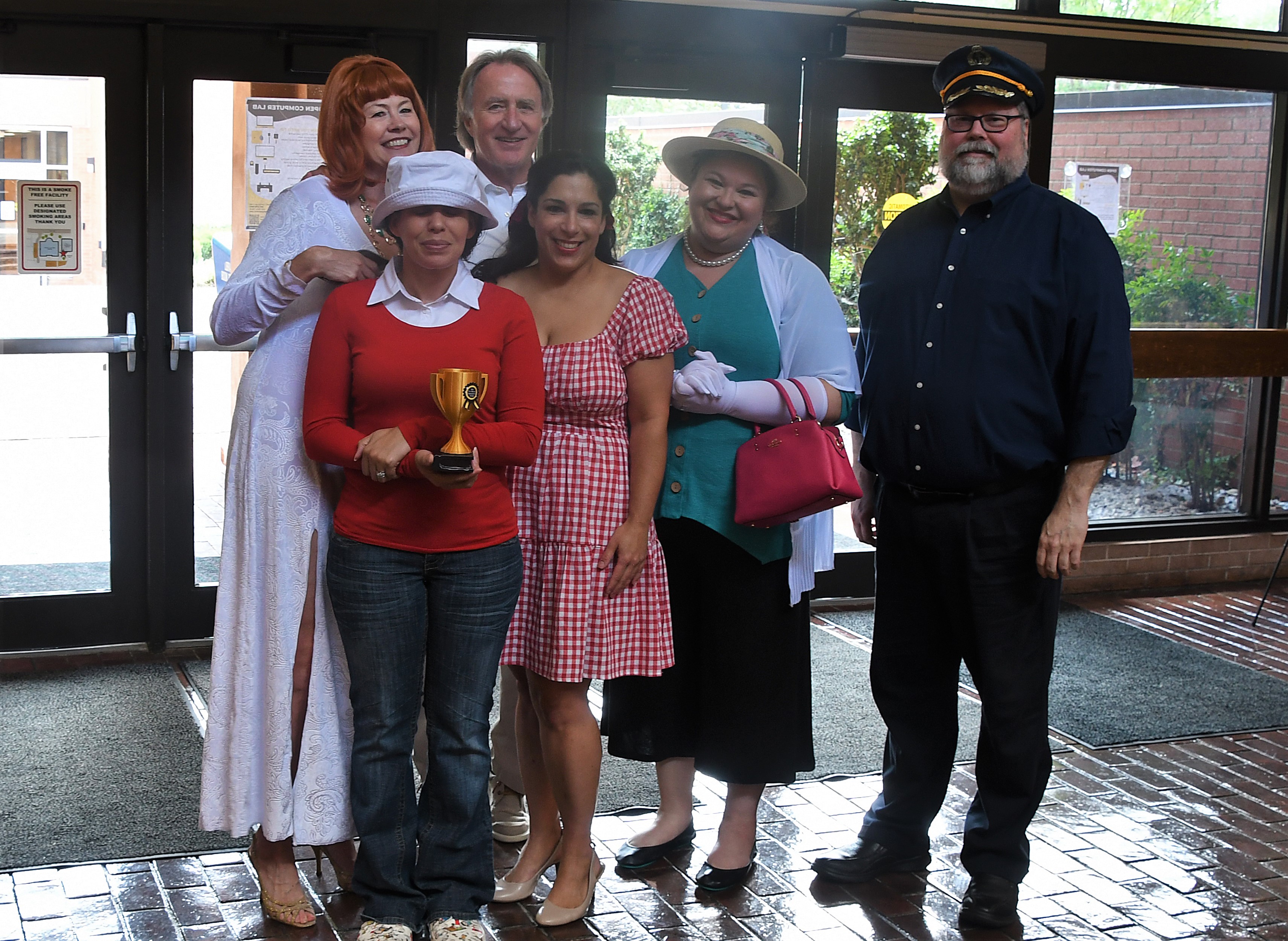 FTCC faculty and administration members, dressed as the characters from Gilligan's Island, hold a trophy for winning the costume contest.