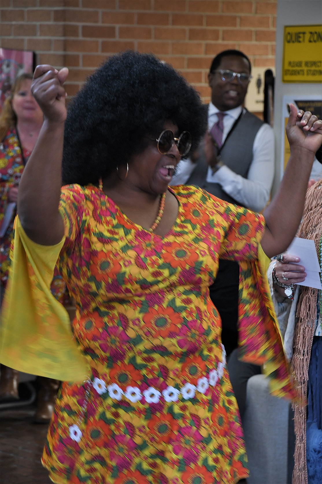Library assistant Catherine Cotton-Aarons, dressed as 1960s go-go dancer, dances during the costume contest.