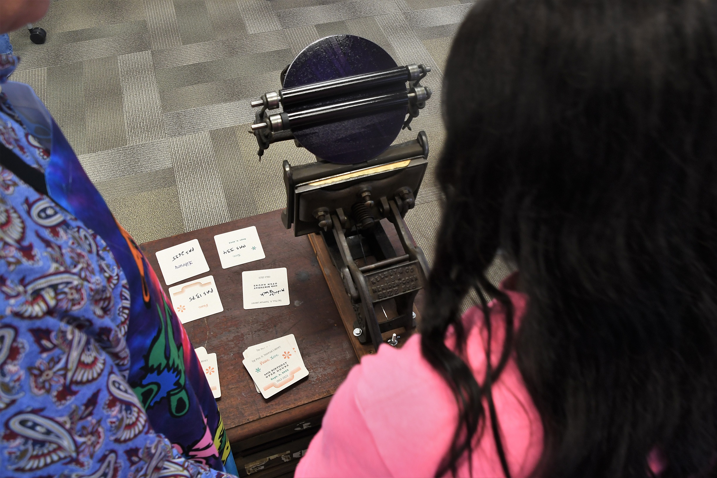 A letterpress is used to print on coasters made of cardstock. 