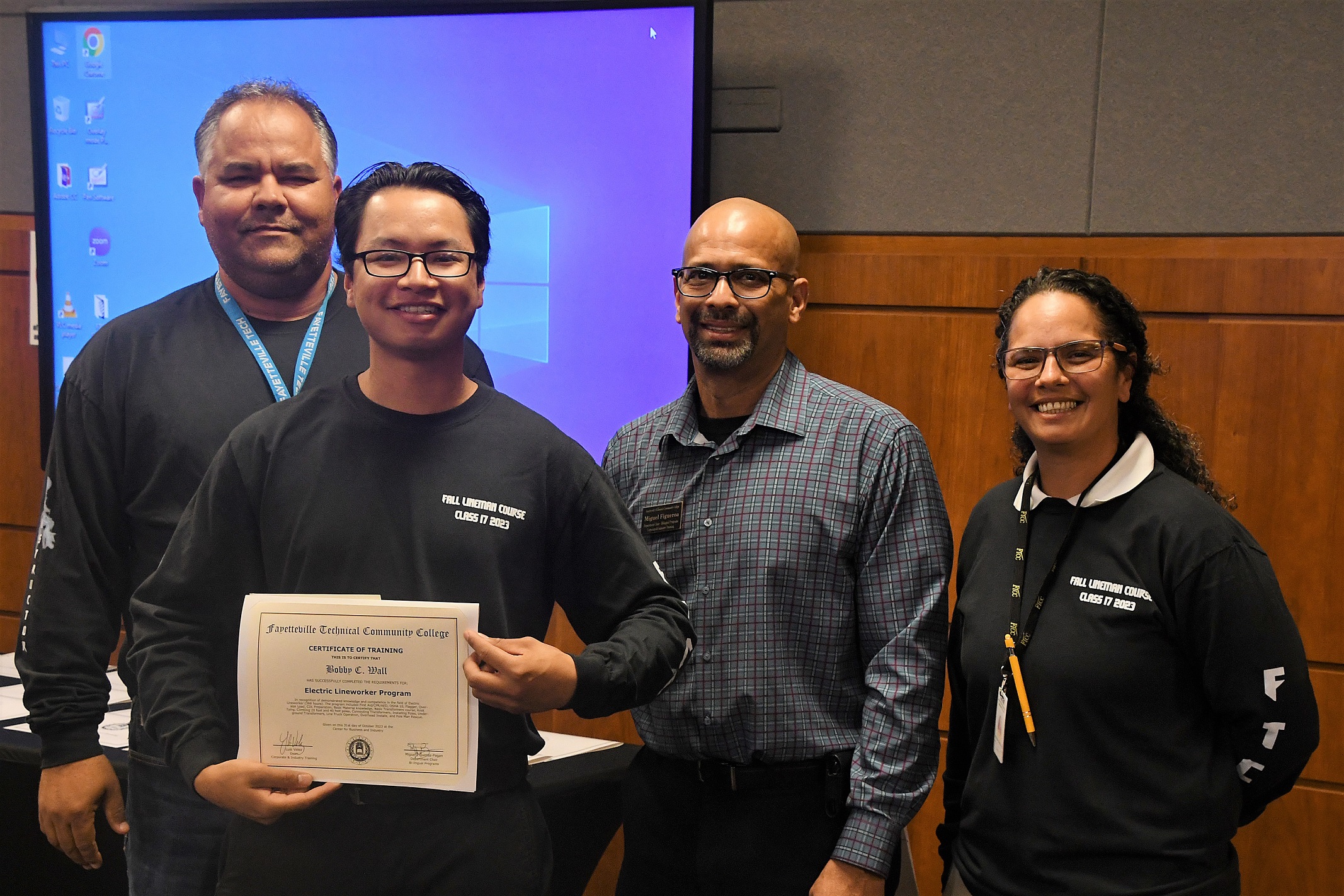 A graduate of FTCC's Electric Lineworker Basic Training course poses after receiving his certificate.