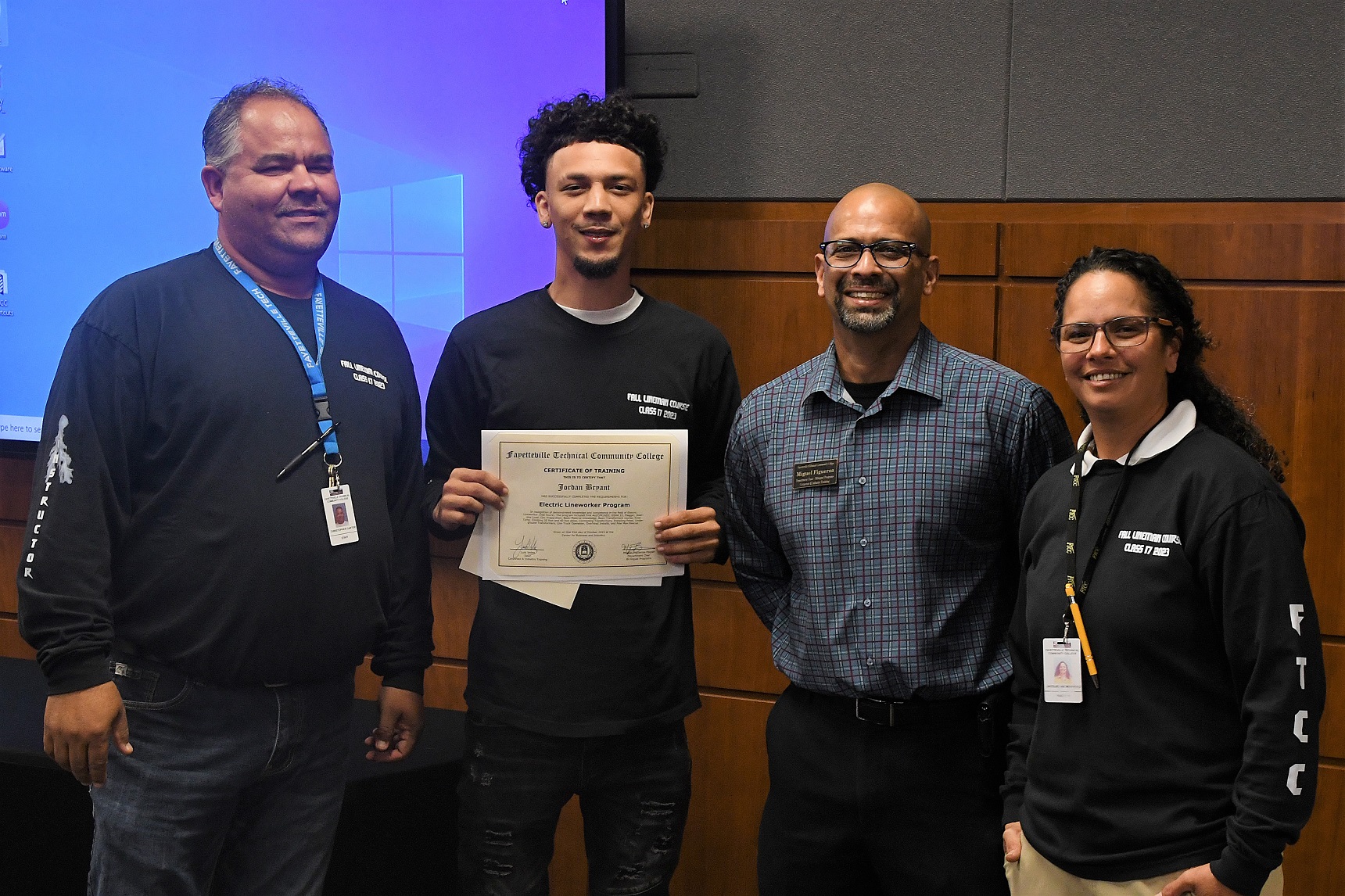 A graduate of FTCC's Electric Lineworker Basic Training course poses after receiving his certificate.