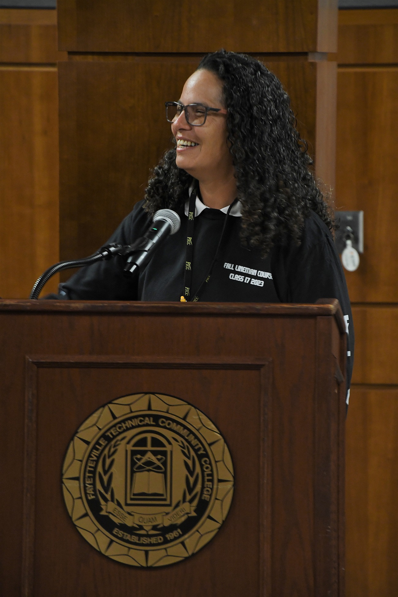 Electric Lineworker instructor Jacqueline Montero speaks at the podium.