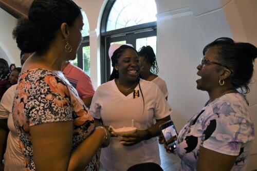 A LPN graduate talks with attendees after the ceremony.