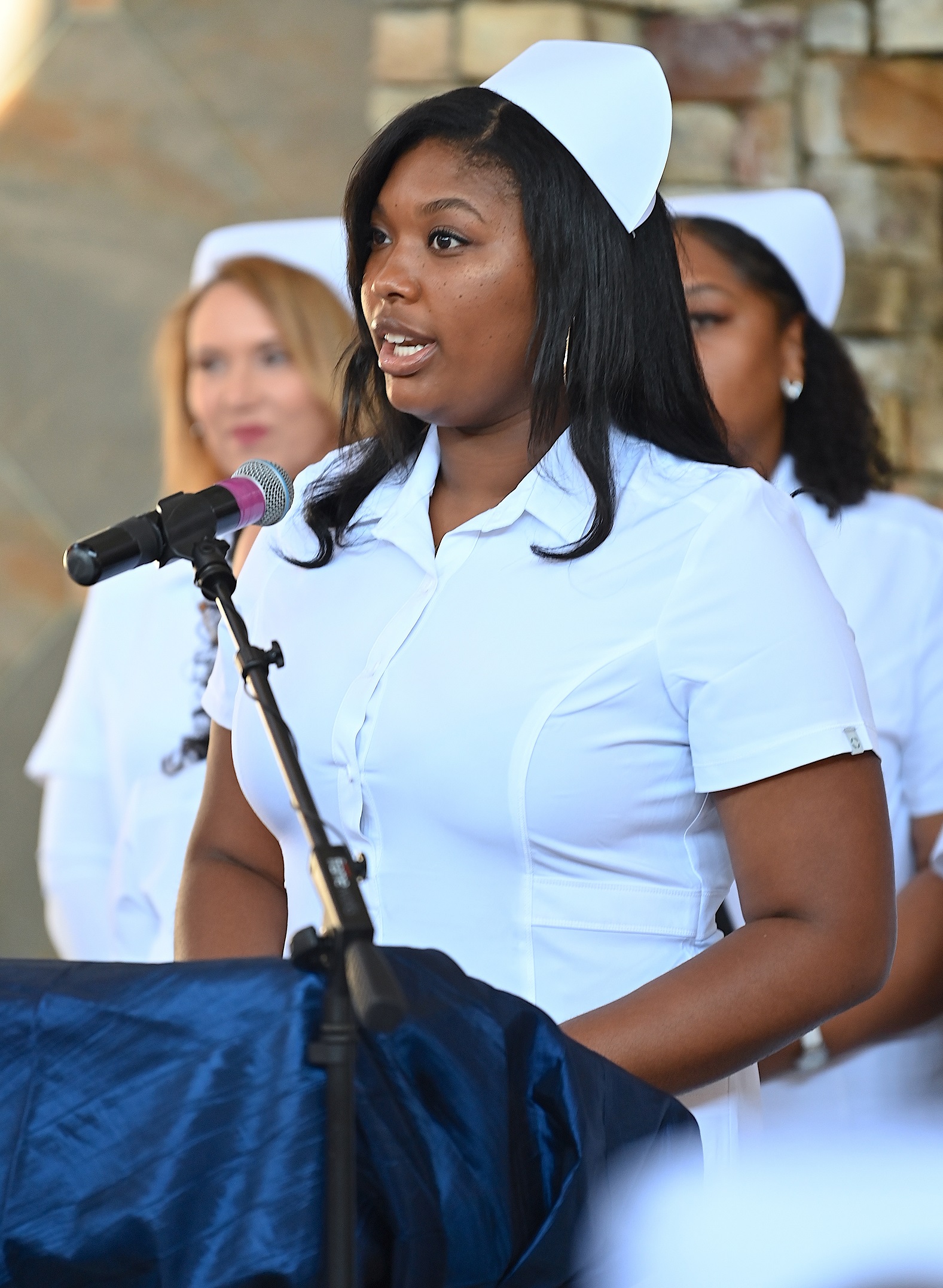 A nursing graduate speaks at the pinning ceremony.