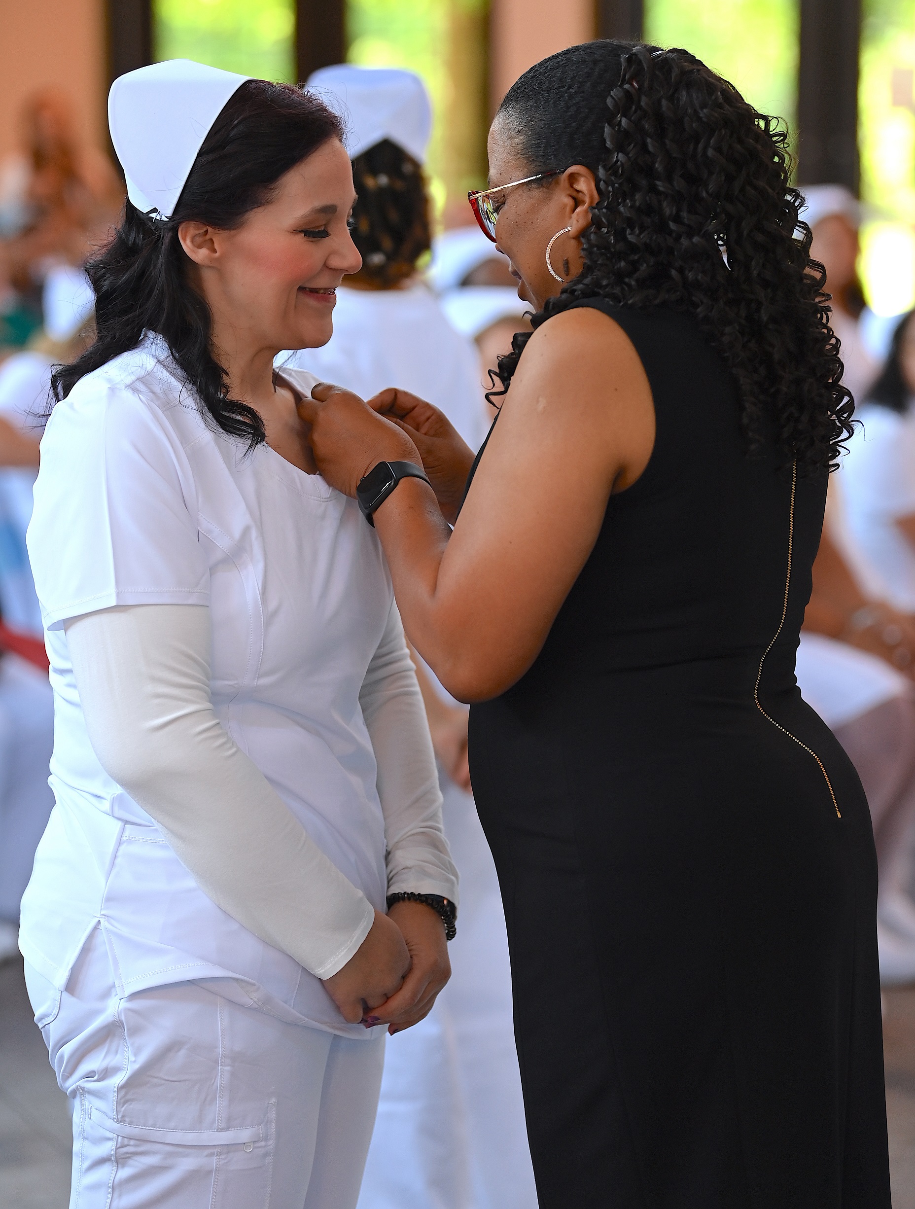 A nursing graduate receives her pin.