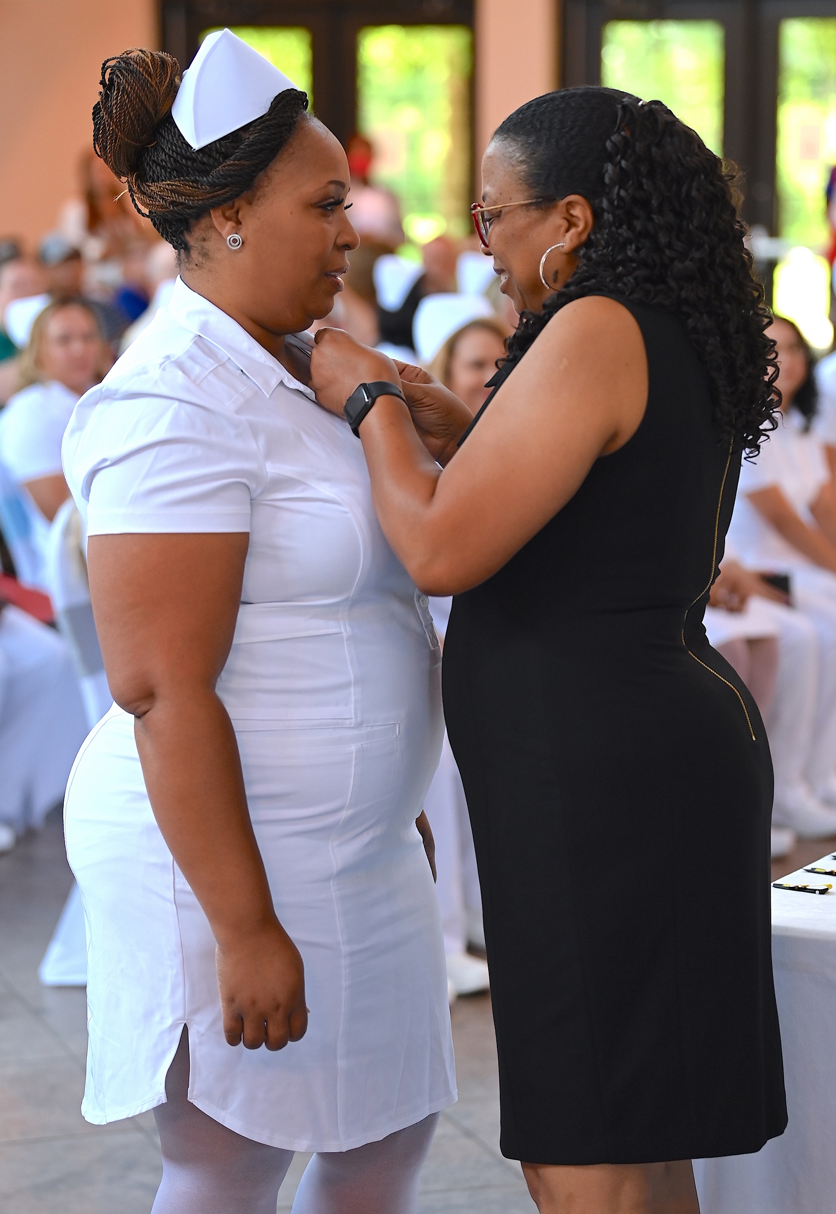 A nursing graduate receives her pin.