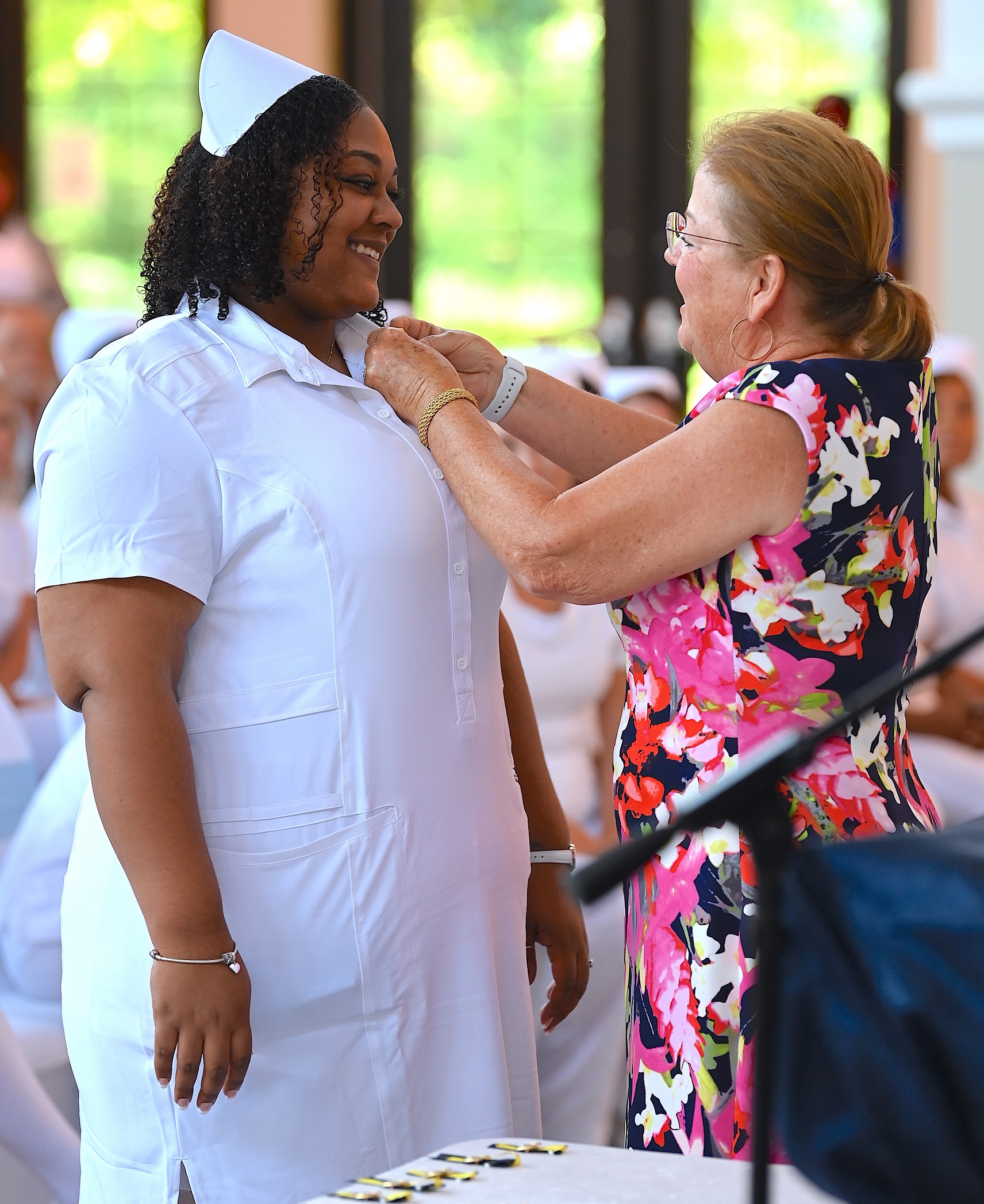 A nursing graduate receives her pin.