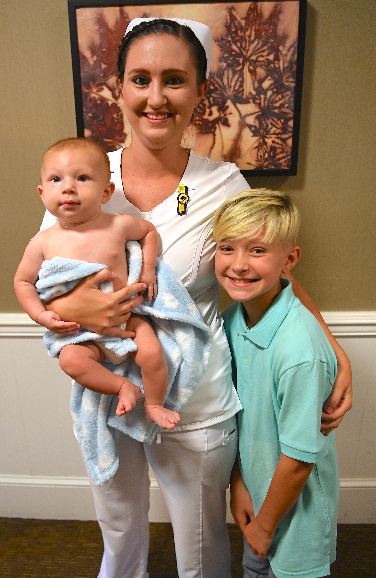 A nursing graduate poses for a photo with her family.