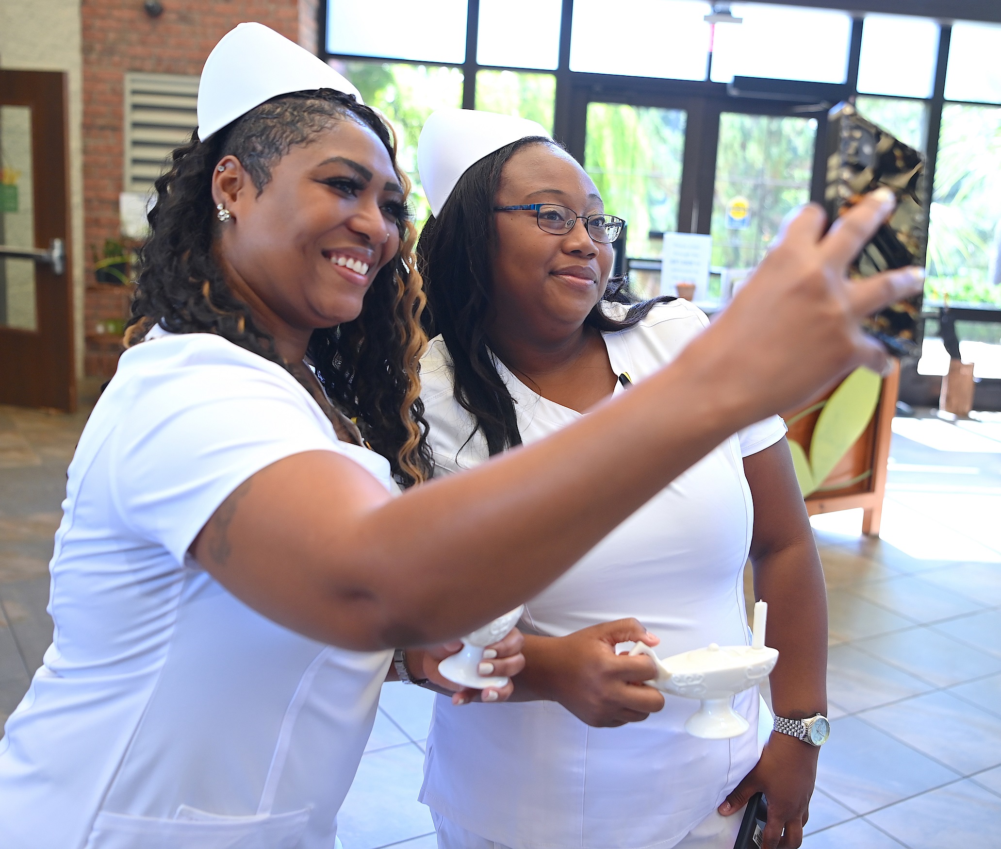 Two nursing graduates take a selfir.