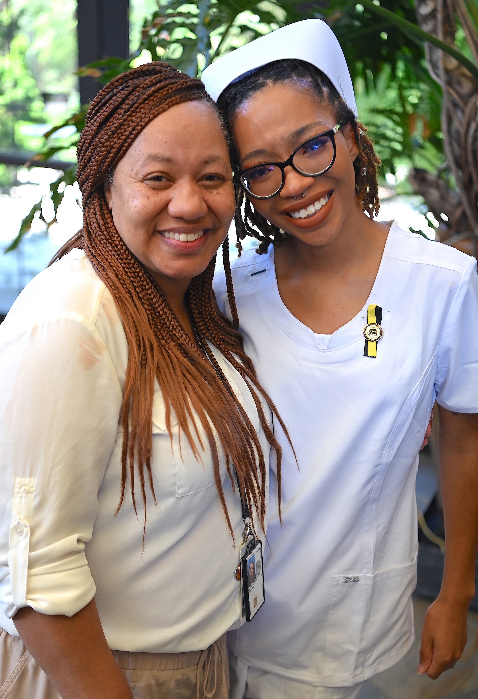A nursing graduate smiles for a photo with a loved one.