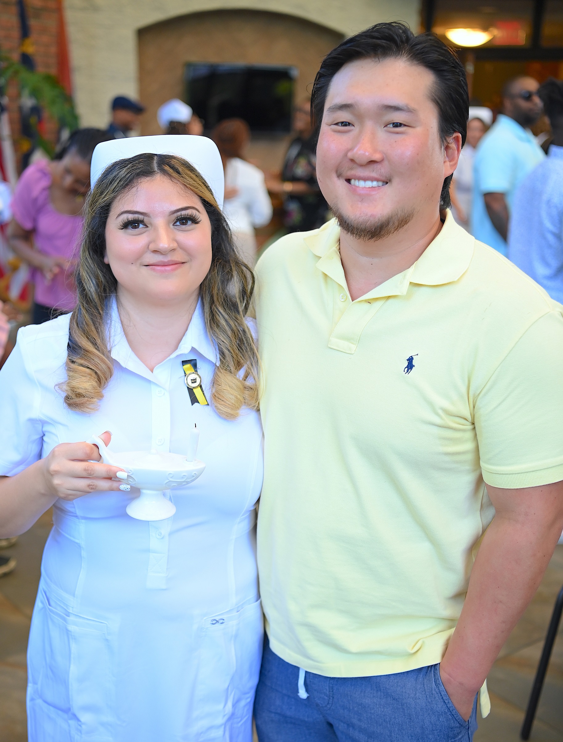 A nursing graduate poses for a photo with a loved one.