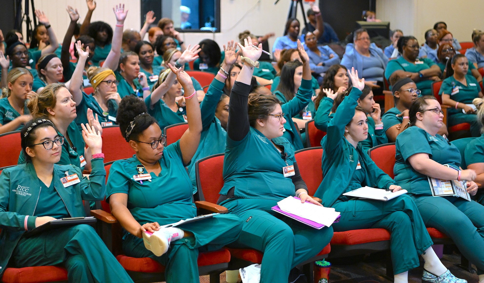 FTCC Nursing students raise their hands to answer a question during Nurse Blake's Beyond the Books visit. [Photo by Brad Losh]