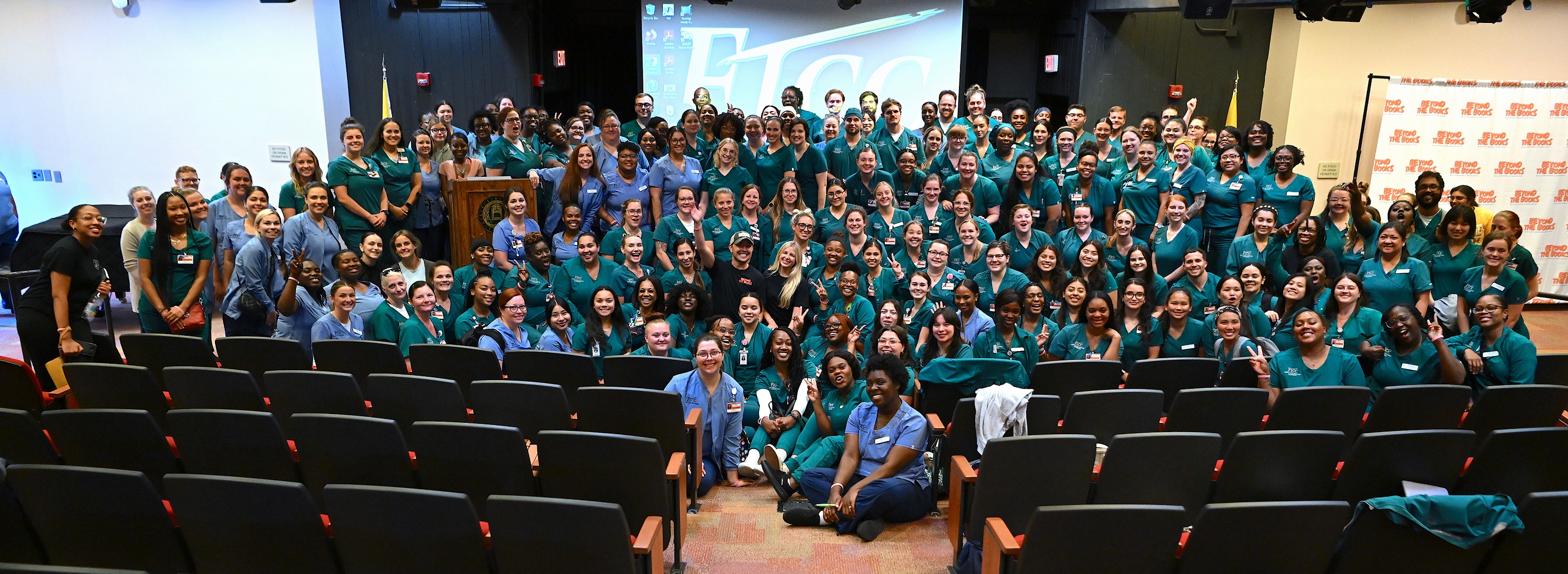 FTCC Nursing students and instructors pose for a group photo with Nurse Blake and Stephanee Beggs on the stage in Cumberland Hall Auditorium. [Photo by Brad Losh]