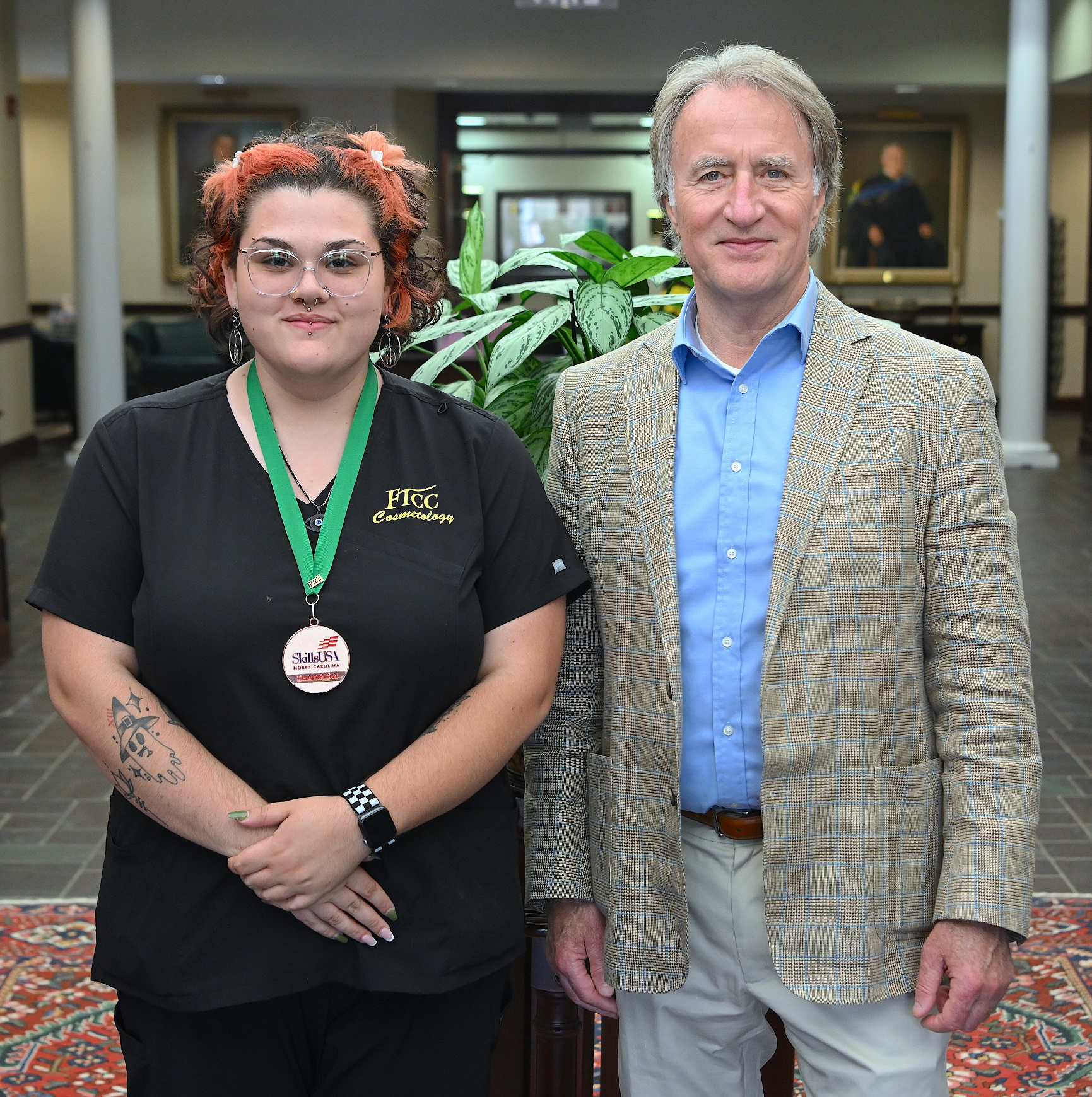 Destiny Delgado (5th place, Hair Coloring) stands with FTCC President Dr. Mark Sorrells.