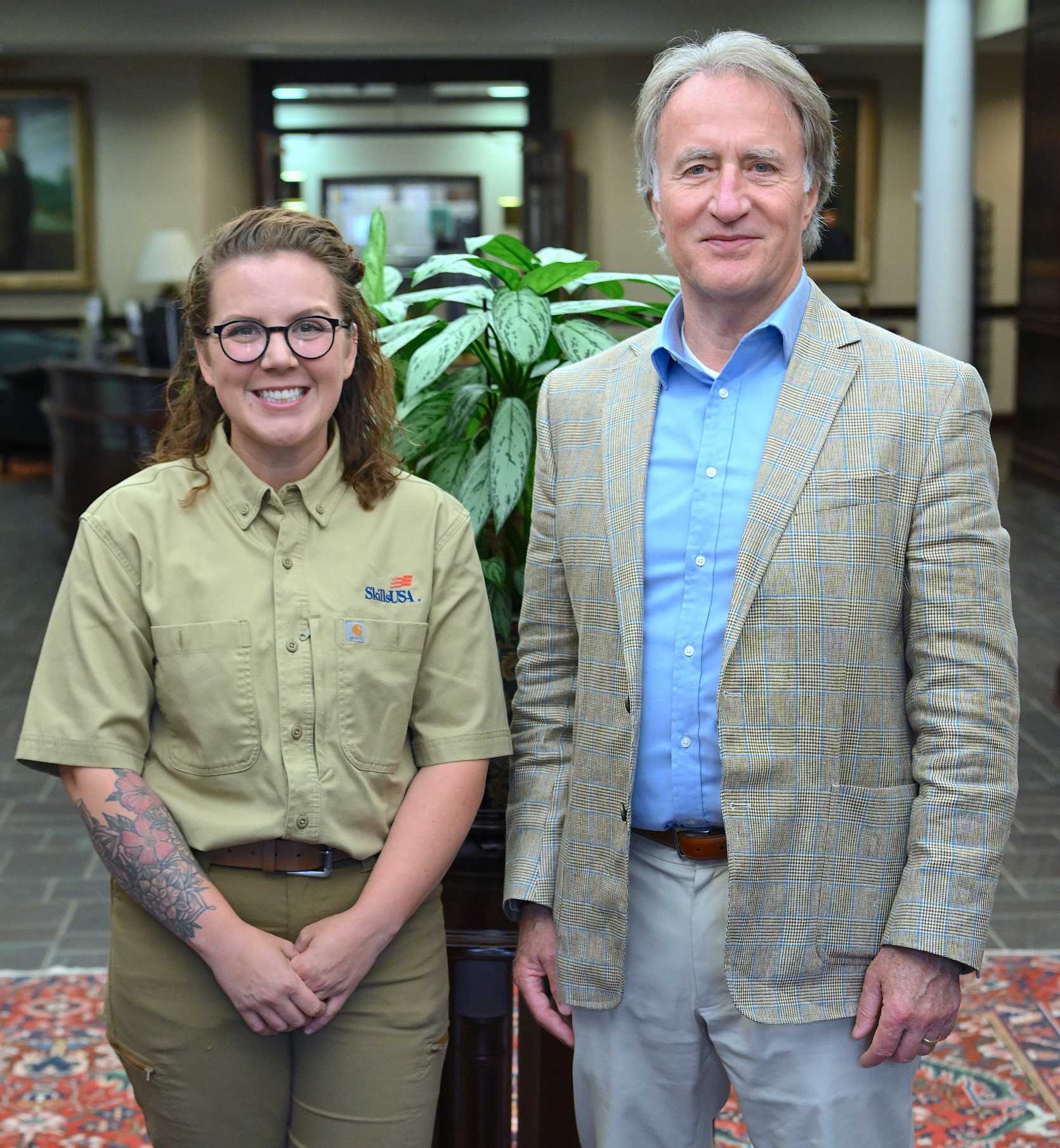 Hailey Greenwell (1st place, Electrical Construction Wiring) stands with FTCC President Dr. Mark Sorrells.