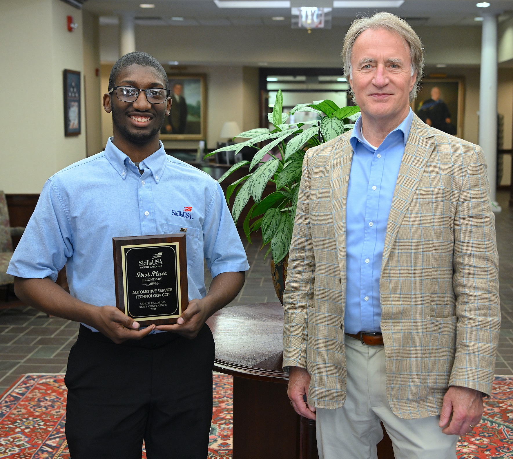 Javon Lewis (1st place, Automotive Systems Technology) stands with FTCC President Dr. Mark Sorrells.