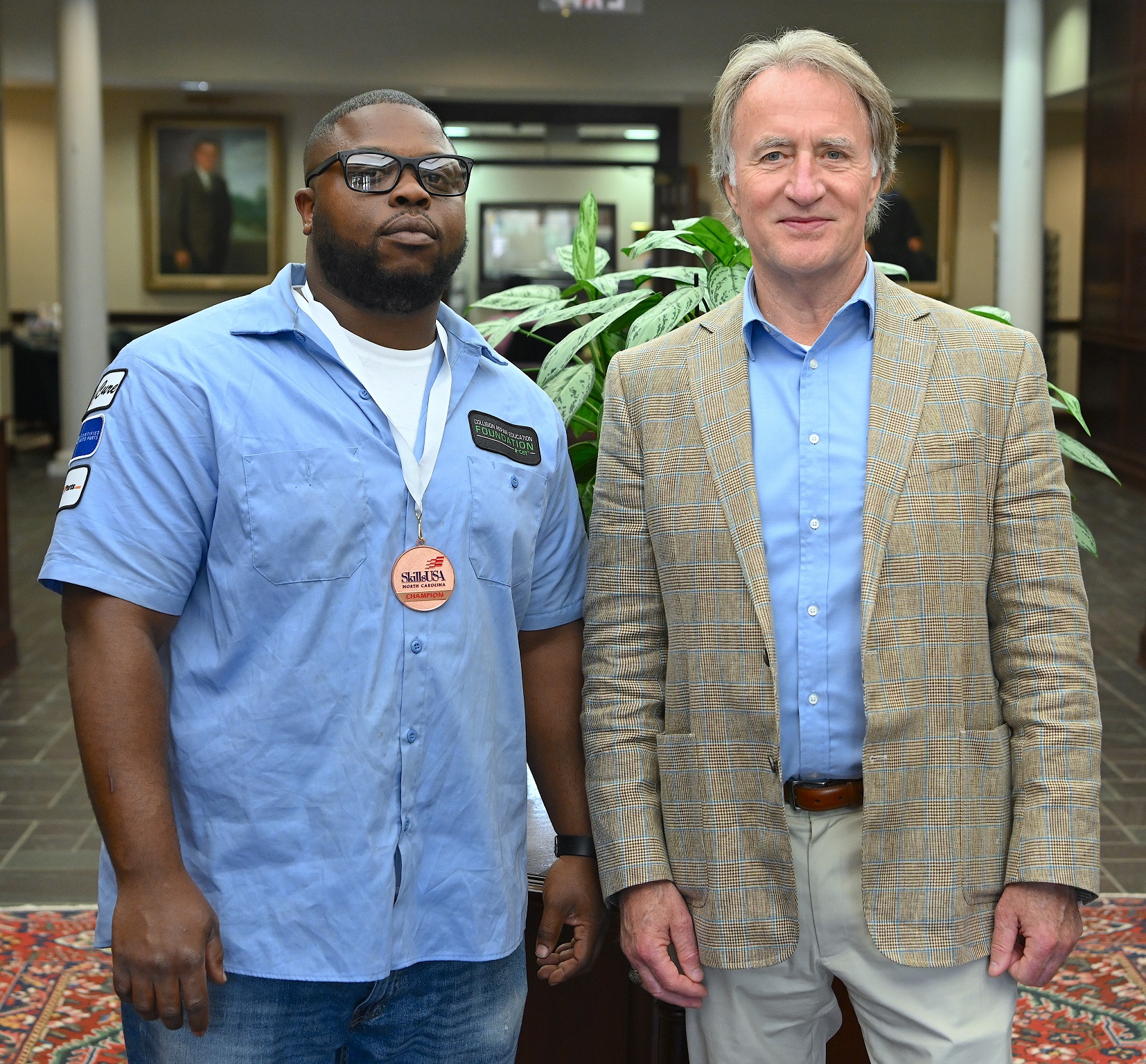 Joshua Williams (3rd place, Collision Repair Technology) stands with FTCC President Dr. Mark Sorrells.