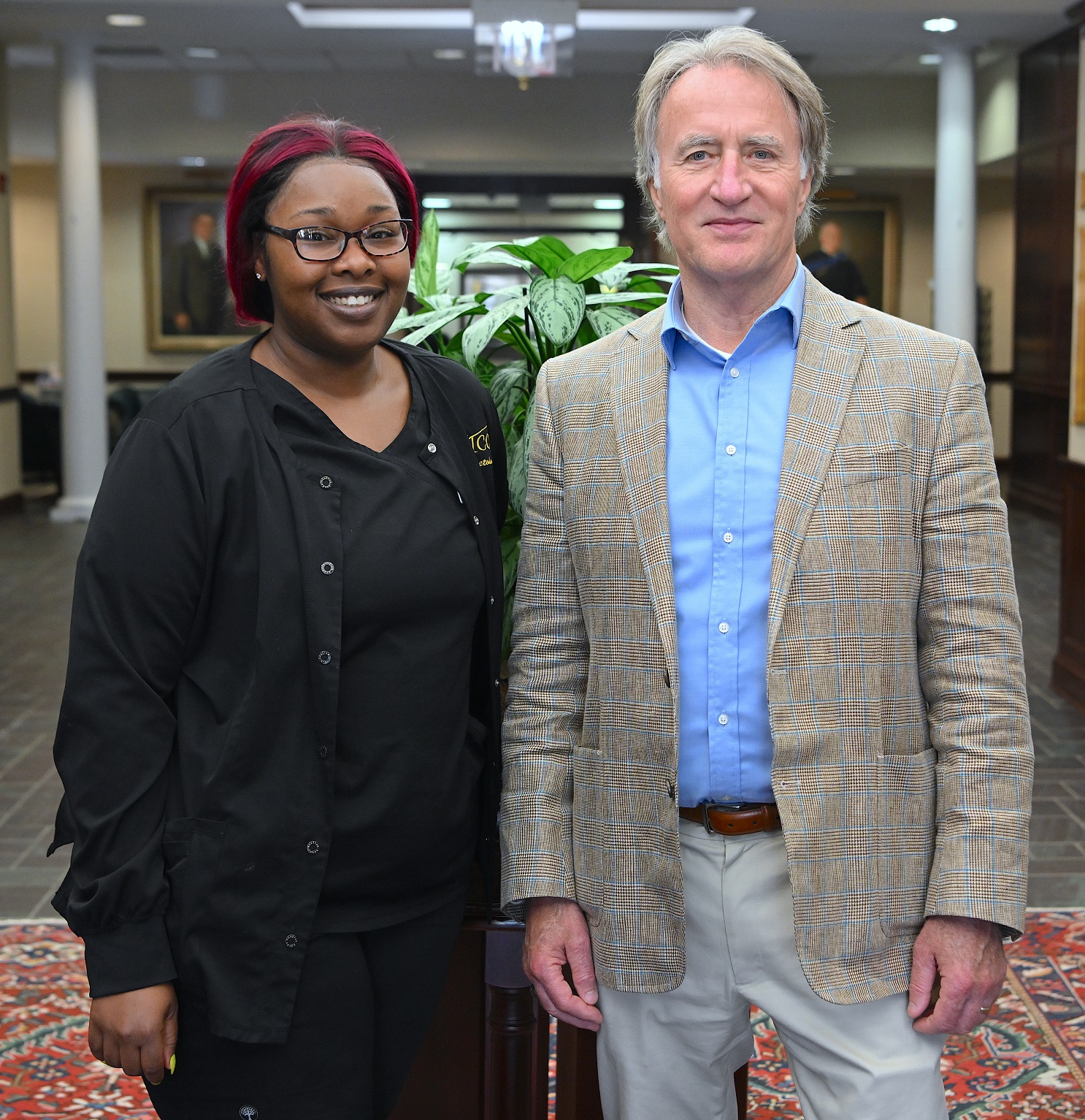 LaQuiesha Spellman (2nd place, Skilled Showcase-Cosmetology, and 3rd place, Hair Coloring) stands with FTCC President Dr. Mark Sorrells.