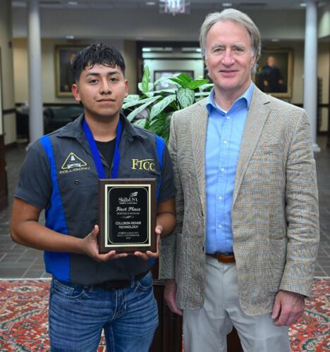 Hector Santos Medina (1st place, Collision Repair Technology) stands with FTCC President Dr. Mark Sorrells.