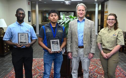 First-place finishers Javon Lewis (Automotive Systems Technology), Hector Santos Medina (Collision Repair), and Hailey Greenwell (Electrical Construction Wiring) stand with FTCC President Dr. Mark Sorrells.