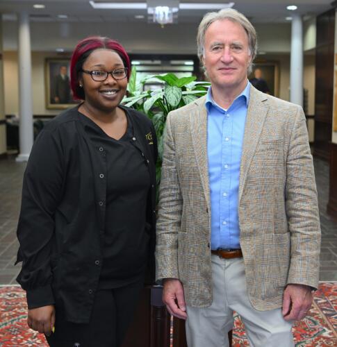LaQuiesha Spellman (2nd place, Skilled Showcase-Cosmetology, and 3rd place, Hair Coloring) stands with FTCC President Dr. Mark Sorrells.