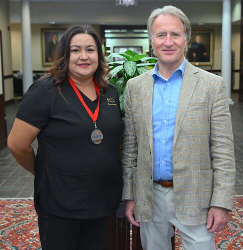 Yara Sanchez (2nd place, Fantasy Hair & Makeup) poses with FTCC President Dr. Mark Sorrells.