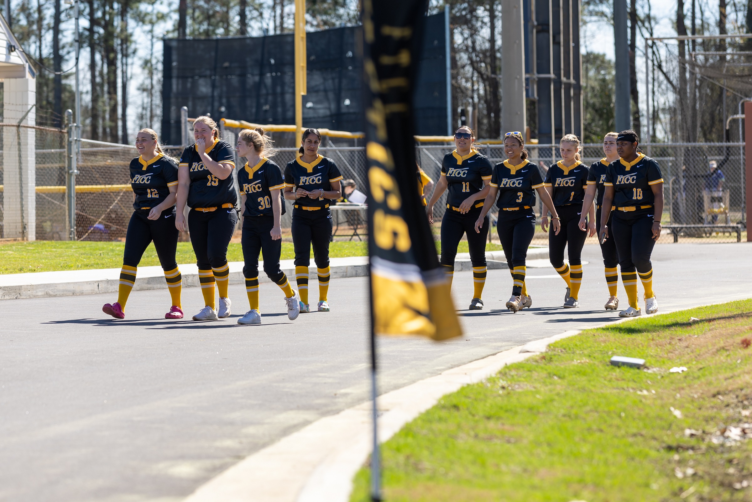 FTCC softball players walk up the path to the new softball field.