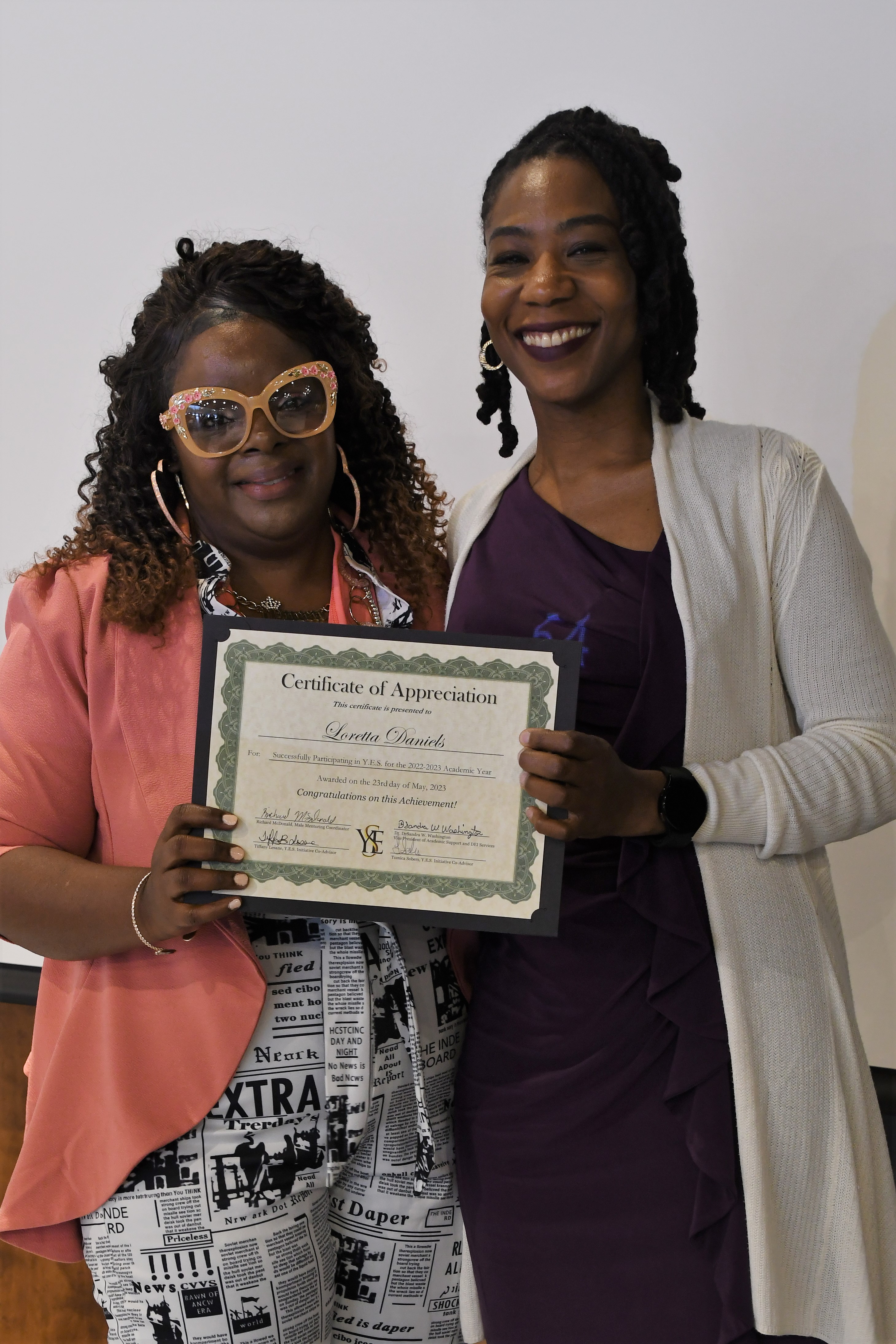 A student receives her Certificate of Appreciate for participating in the YES Initiative.
