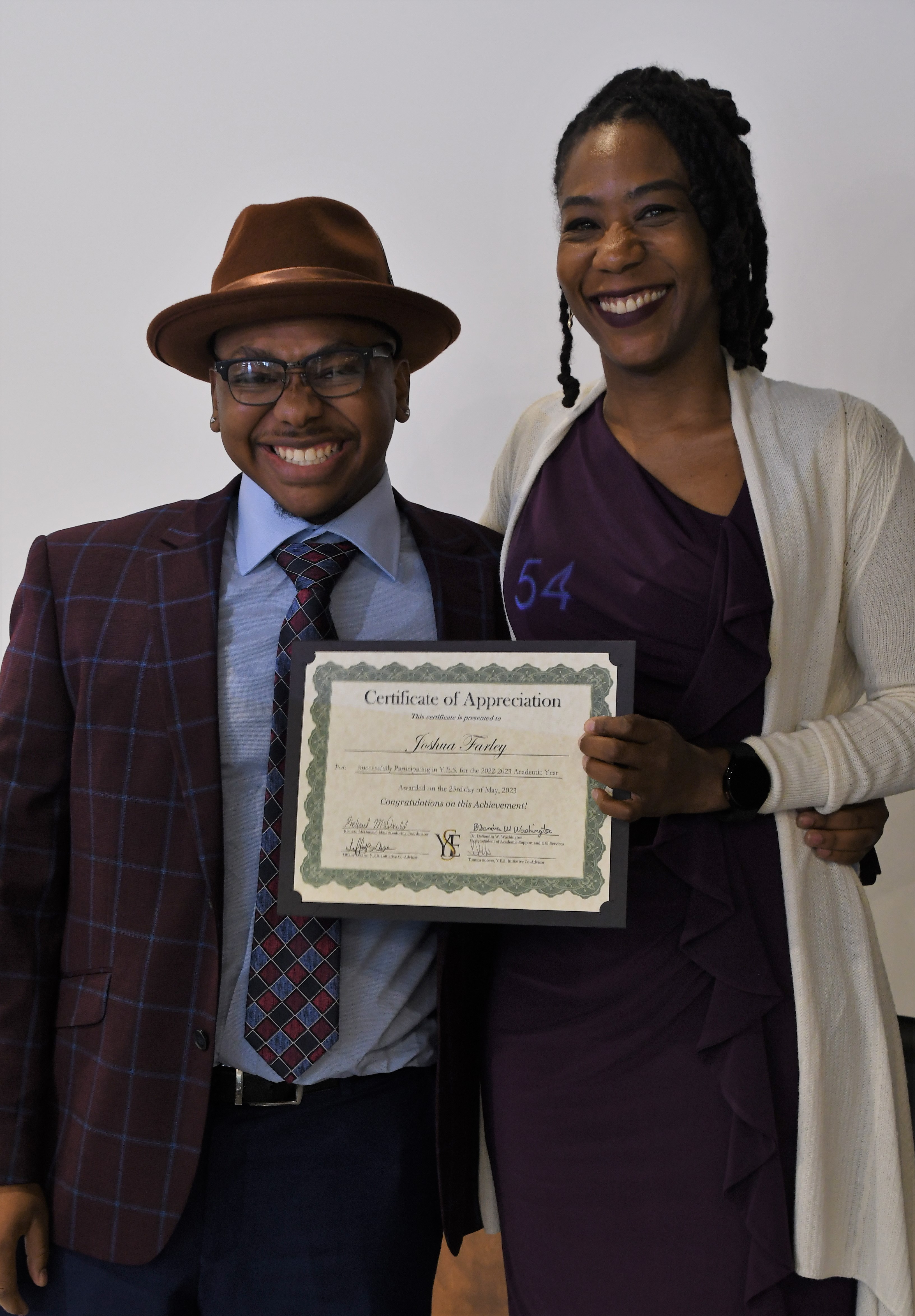 A student receives his Certificate of Appreciate for participating in the YES Initiative.